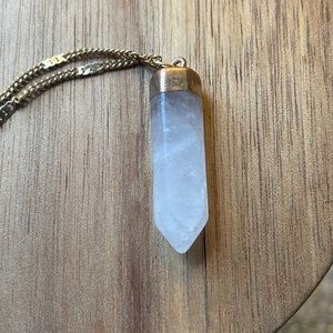 Pretty, long, crystal pennant with gold colored chain.